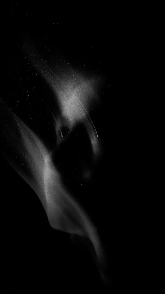 Abstract long-exposure figure emerging from darkness
